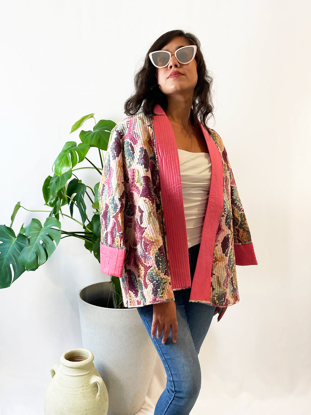 Woman wearing a colorful pink quilted short jacket